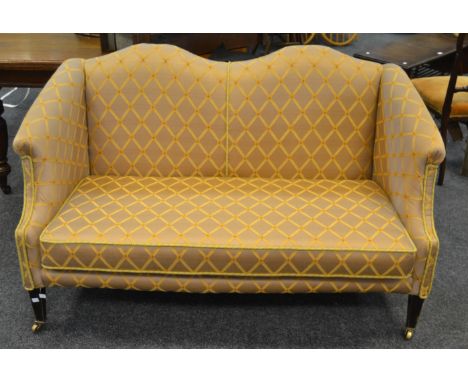 An early 20th century two seater sofa in tones of gold upholstery 