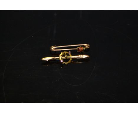 An early 20th century gold coloured metal and enamel insect bar brooch, applied with a lady bird; a 9ct gold and amethyst bar