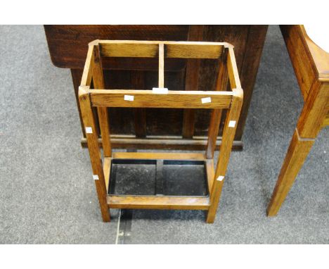 An Arts and Crafts oak double section stick stand, with liner 