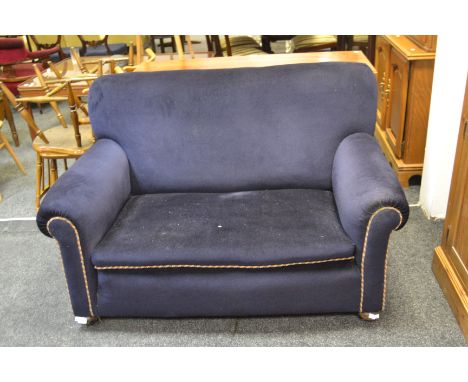 An Edwardian drop arm two seater sofa, bun feet 