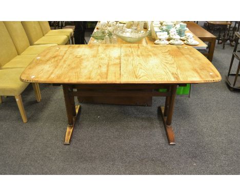 An Ercol 954 Burford extending table, 6 to 12 seater, gold label, stripped top