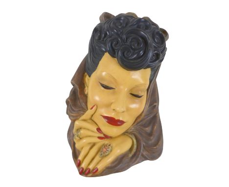 An Art Deco style plaster wall mask, 24 by 37cm.Generally, good condition. 