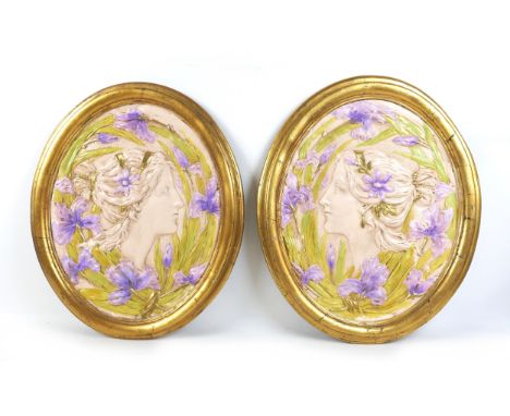 Two Art Nouveau style wall plaques, late 20th century, depicting two female profiles, with gold oval borders, each 58.5 by 48
