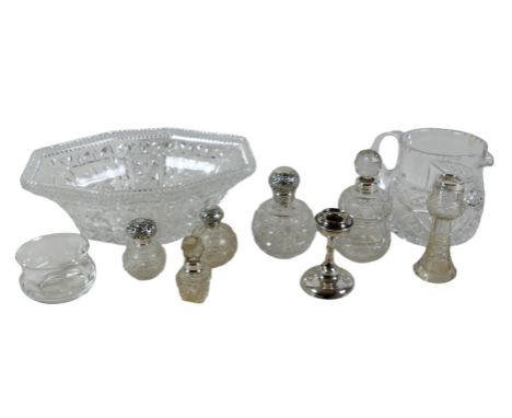 A group of silver topped cut glass bottles, three ovoid with silver tops, two and a vase with silver collars, together with a