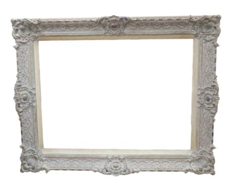 A large rectangular framed mirror, with ornate plaster frame, 