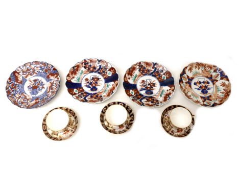 A group of four Japanese 19th century plates, decorated in the Imari palette, with scalloped rims, comprising one pair and tw