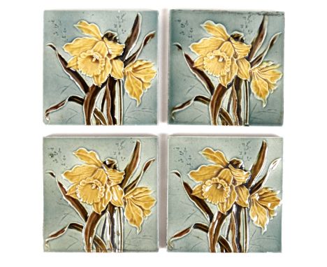 A set of four Art Nouveau tiles, by Henry Abraham Ollivant, each decorated with a daffodil, 15.5 by 15.5cm. (4) 