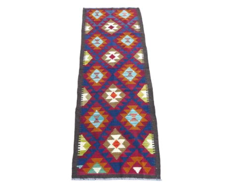 Brown edged multicoloured geometric hand knotted woollen runner rug, 192 by 66cm. 