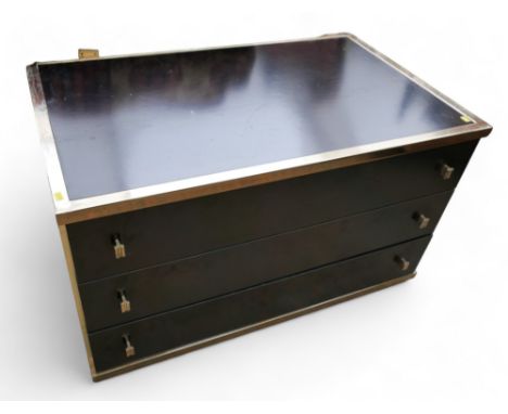 A black and brass display shelf / drawer unit with three drawers and glass shelves. 