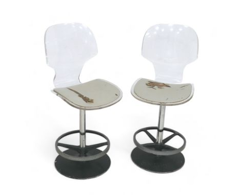 A pair of clear Perspex vintage bar stools, leather seats a/f, with black circular bases, 43.5 by 49 by 103cm high. (2) 