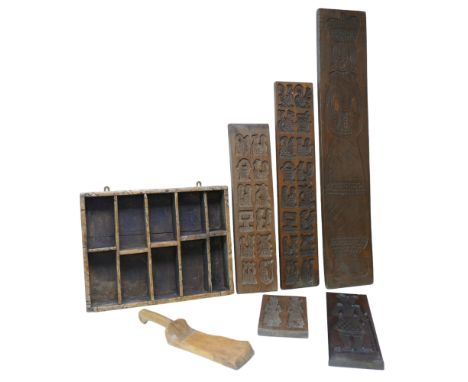 A collection of wooden biscuit moulds, largest, 101cm long, together with a country made spice rack. (qty) 