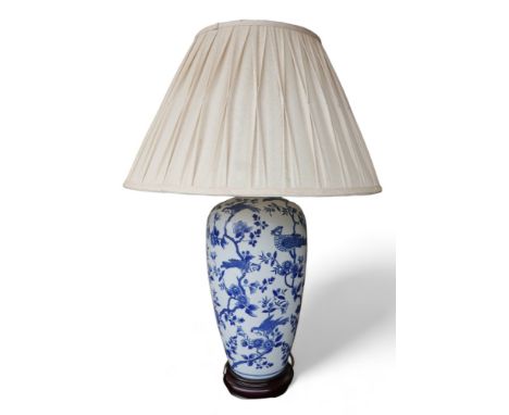 An Oriental style blue and white table lamp with shade, 56cm by 83cm tall. 