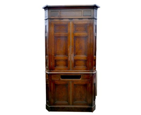 A Georgian oak corner cupboard, in two sections, inlaid ebony detail to the frieze, with brass trim on cupboard doors, and fo