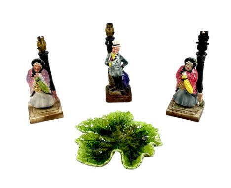 A group of four pieces of Bretby pottery, comprising two Sairey Gamp Dickens character lamp bases, one Mr Micawber lamp base,