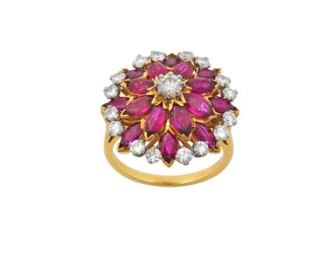 A Ruby and Diamond Cluster Ringthe central raised round brilliant cut diamond within a double stepped border of marquise cut 