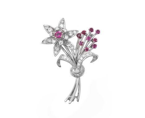 A Ruby and Diamond Brooch realistically modelled as a stylised floral spray, set throughout with round cut rubies, round bril