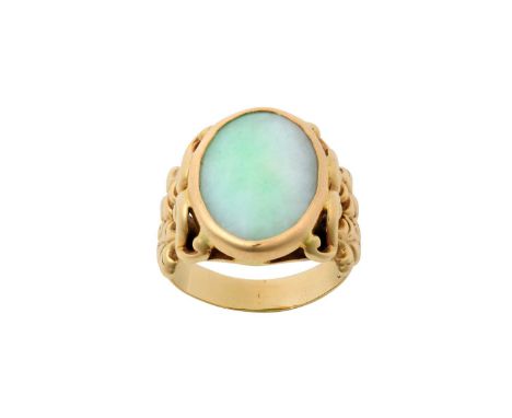 A Jade Ringthe oval jade plaque in a yellow rubbed over setting, to a scroll shoulder plain polished shankfinger size RThe ri