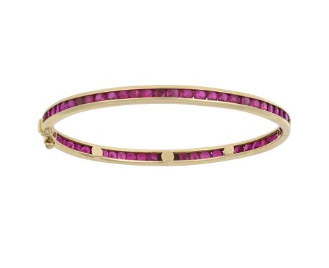 A Ruby Hinged Banglethe round cut rubies in yellow channel settingsinner measurements 6.1cm by 6.0cmThe bangle is in good con