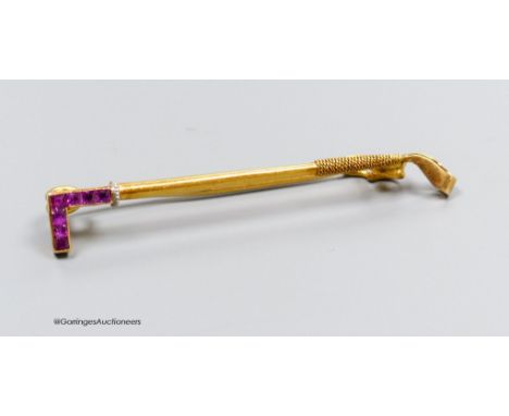   A Lacloche Freres gold and ruby riding whip brooch, signed, gross 3g, 5cm. In original box.