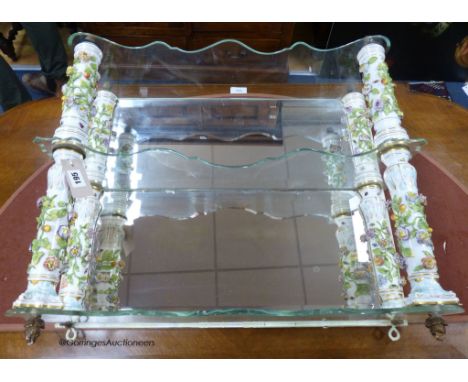   A German porcelain and glass three tier wall bracket, width 65cm, depth 18cm, height 58cm