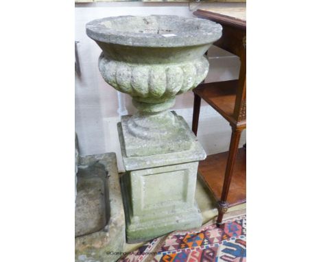   A reconstituted stone campana garden urn on plinth, 40cm diameter, 82cm high