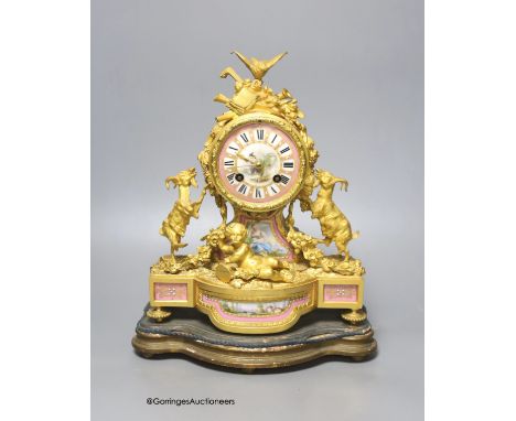   A 19th century French ormolu and porcelain mantel clock, with key and pendulum, overall height 33cm