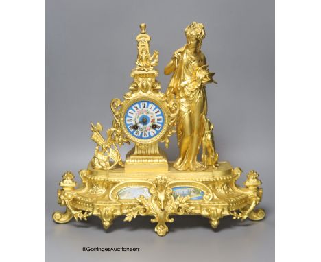   A late 19th century French gilt metal figural mantel clock, with Sevres style inserts, with key and pendulum, height 42cm