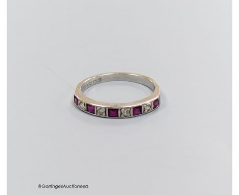   And 18 carat white gold ruby and diamond half eternity ring, size O, gross 2.7g.