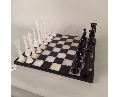 An ornate hardstone chess set with hardstone board