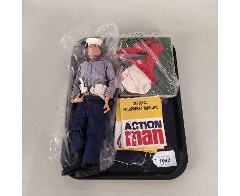 An early Action Man with sailor uniform, a World Cup football kit and stand plus nine equipment manuals