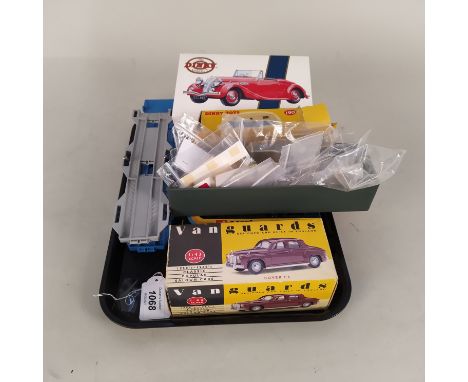 A Corgi car transporter, four boxed Dinky and Corgi vehicles, an empty box for 190 caravan plus loose spares