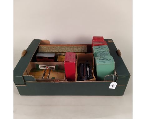 A vintage Hornby tin plate station, a boxed level crossing, various boxed wagons and two loose examples plus a boxed tank loc