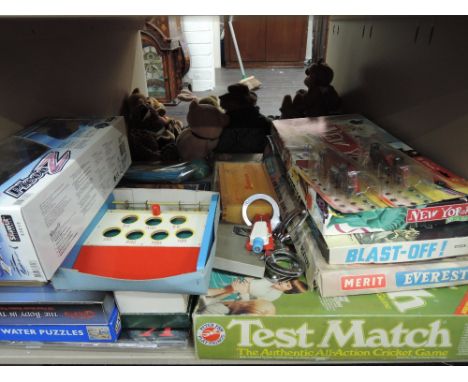 A shelf of vintage and modern games and toys including Peter Pan Test Match, Merit Everest etc