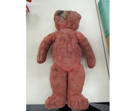 A 1920's Chad Valley straw filled red plush Teddy bear having plastic eyes, stitched nose and mouth and jointed body