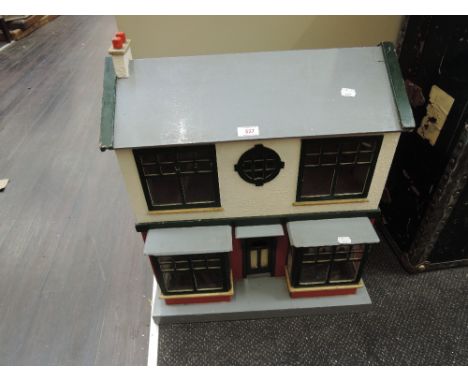 A vintage wooden two tier dolls house having double French windows