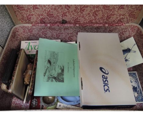 A suitcase containing a selection of miscellaneous including Parker pen, Ranson lighters, pocket watch, ceramics, lucky charm