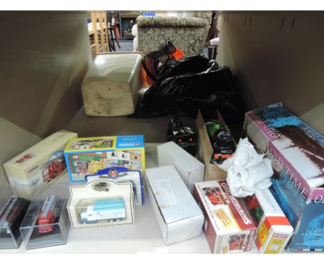 A shelf of modern die-cast vehicles and ceramic ornaments including Corgi (china) all boxed