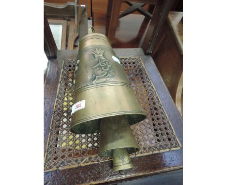 A vintage brass Tibetan hand/cow bell having relevant motifs