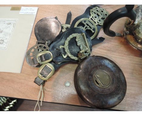 A selection of early 20th century horse brasses and a vintage tape measure, stamped BR (E) E. & N.E.
