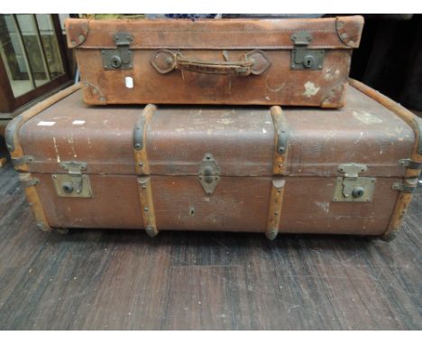 A vintage leather travel trunk having wooden strengthening bars and a vintage leather suitcase
