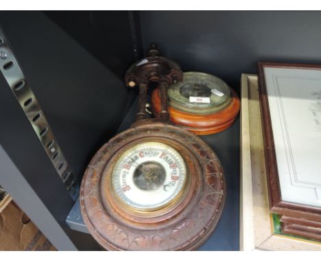 An early 20th century aneroid barometer and a similar barometer