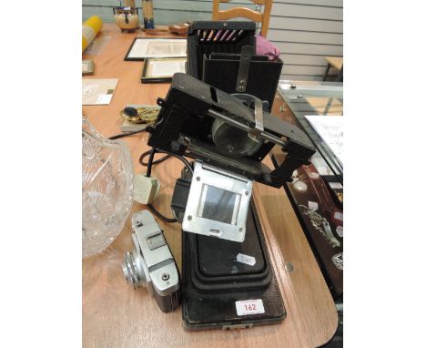 A vintage photographic enlarger and an Agfa camera