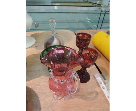 A selection of glassware in 19th century ruby etched port wine glasses, a cranberry jug, green glass tazza etc