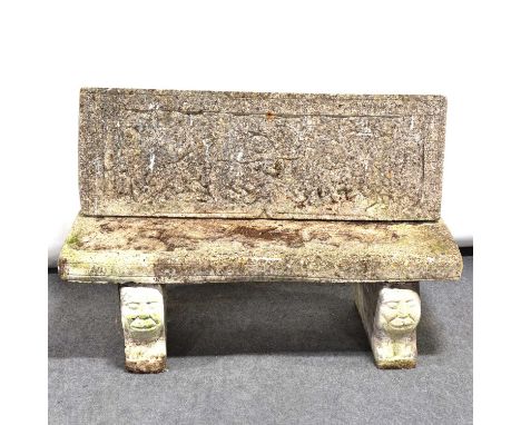 Cast concrete garden bench, rectangular back and seat, mask supports, length 119cm.