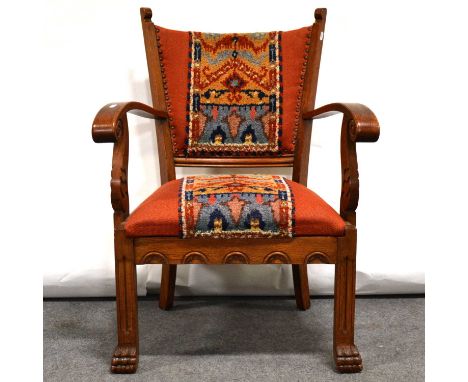 Arts and Crafts style oak armchair, circa 1920s, scrolled carved arms and paw feet, width 69cm, height 91cm.Condition report: