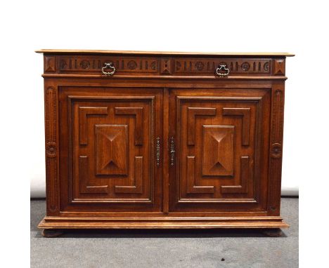 French walnut buffet, 19th century, two frieze drawers carved with foliate roundels, geometric panelled cupboards, flanked by