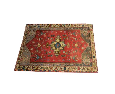 Persian wool rug, central medallion against a crimson red field with birds and lanterns, enclosed by spandrels filled with va