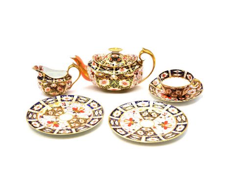 Royal Crown Derby, a harlequin Witches pattern tea service, comprising teapot, six trios, milk jug, sugar bowl (lacking cover