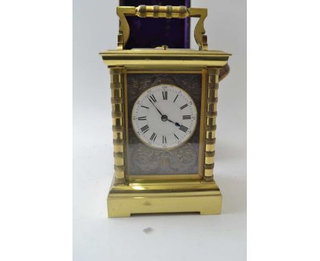 A late 19th century repeating carriage clock, brass case, the circular white enamel dial, with Roman numerals, surrounded by 