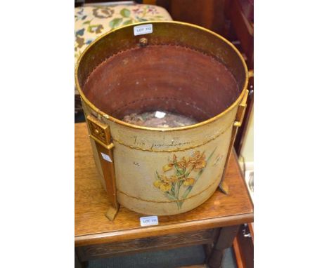 A hand painted metal three legged planter